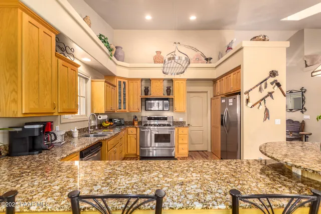 a kitchen with stainless steel appliances granite countertop a stove and refrigerator