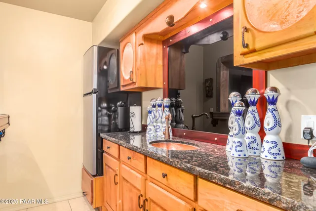 a kitchen with granite countertop a sink and a cabinets