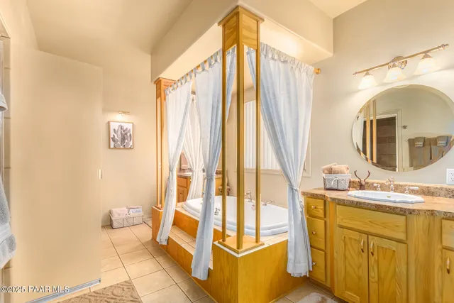 a bathroom with a sink a mirror and a shower