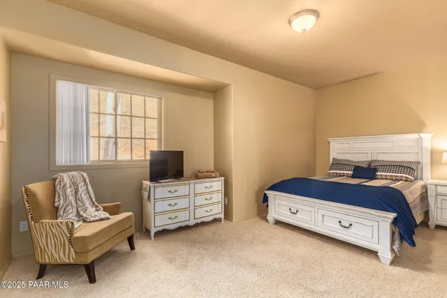 a bedroom with a bed and a couch