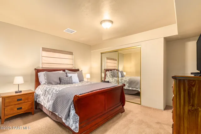 a bedroom with a bed and a mirror