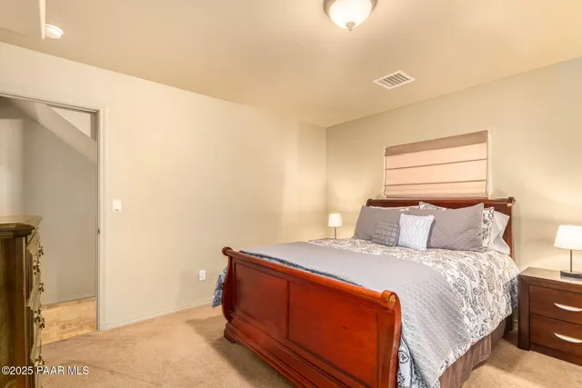 a bed room with a bed and a mirror