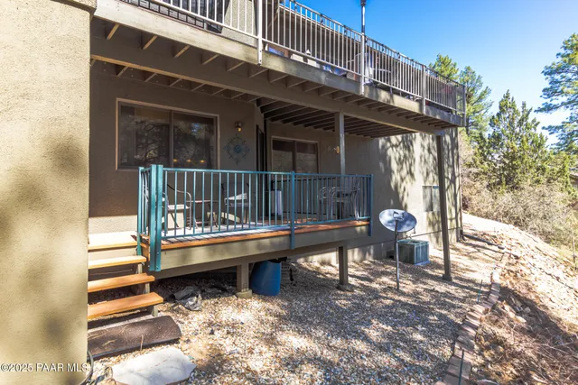 a view of a chairs and table in the balcony
