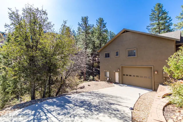 a view of a house with a yard and garage