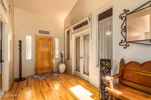 a view of a bedroom with a bed and wooden floor