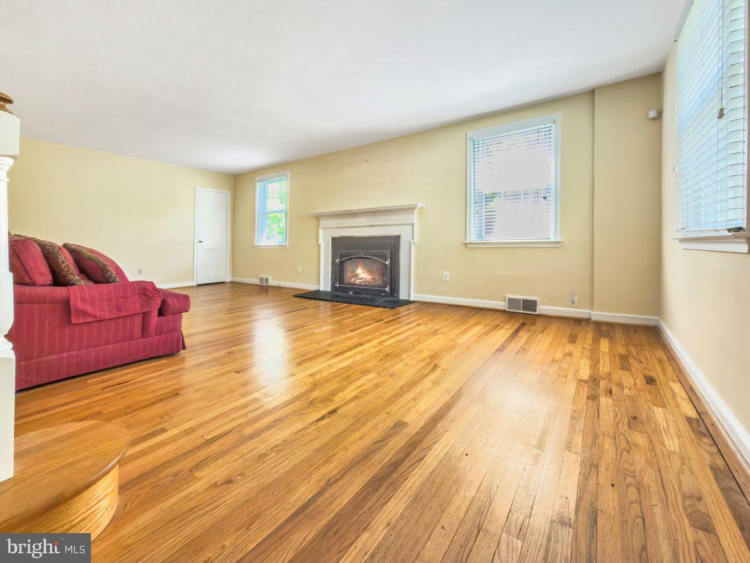 1522 James Road Wynnewood, PA 19096 - Photo 3 of 21 a view of empty room with wooden floor and fireplace