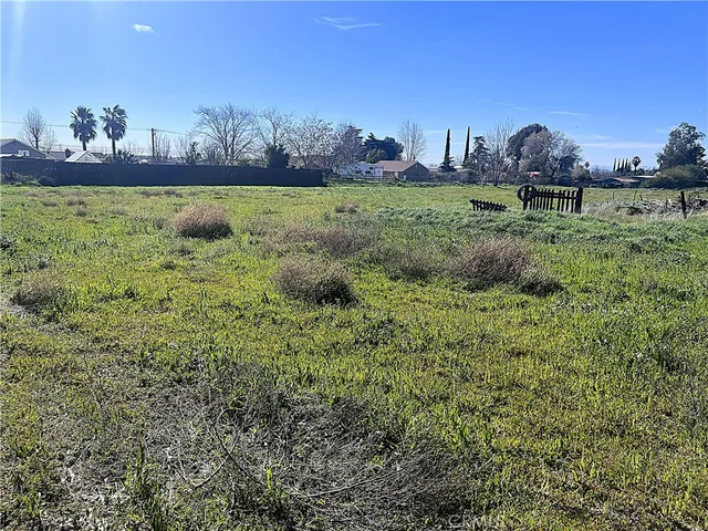 a view of a lush green outdoor space with a swimming pool and valleys in the background