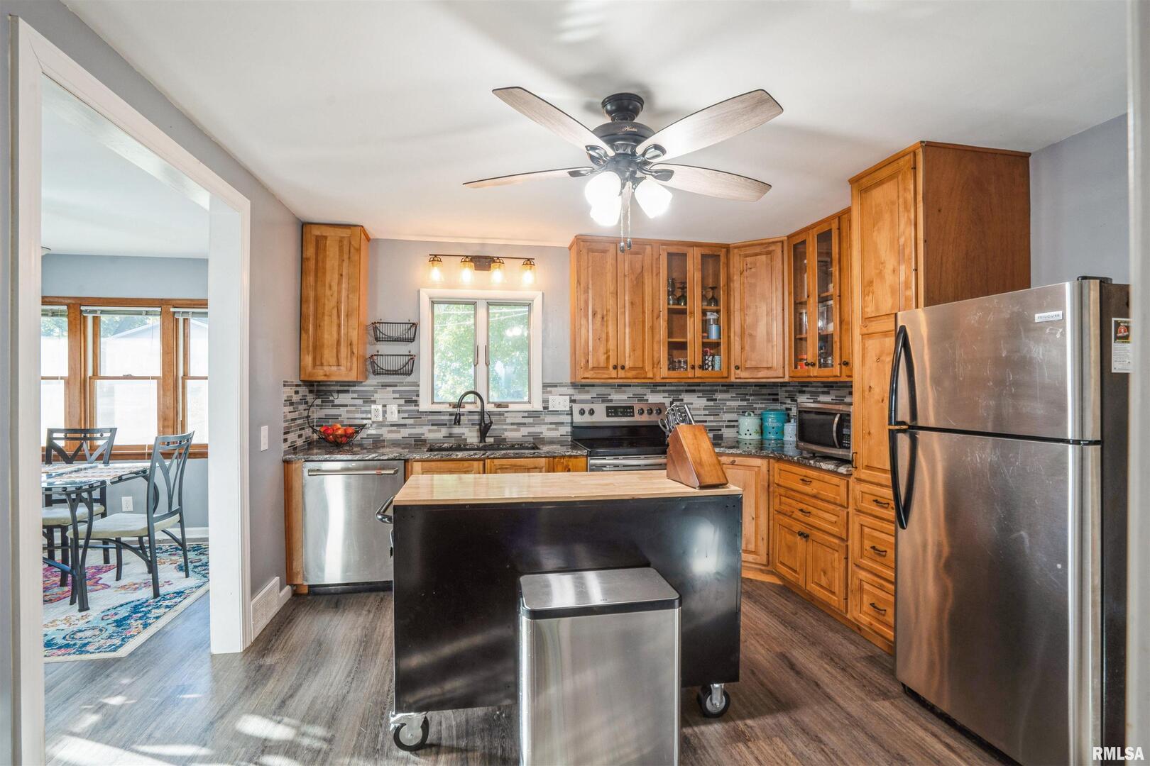 824 9th Avenue Fulton, IL 61252 - Photo 6 of 22 a kitchen with refrigerator a sink and cabinets