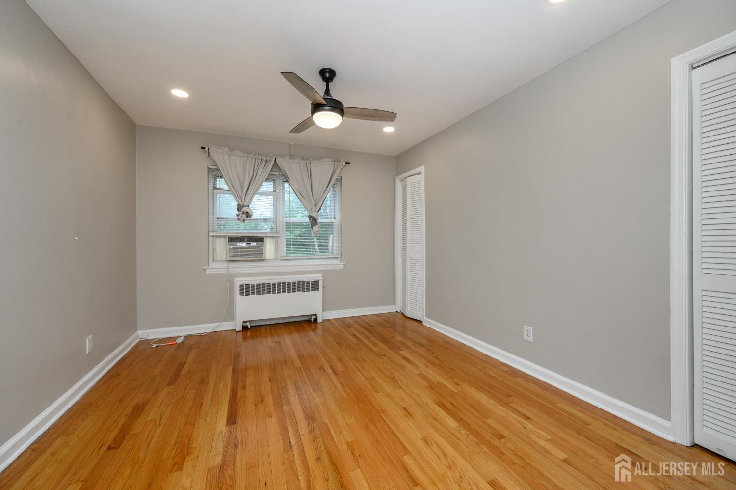 243 Johnson Avenue, Unit L5 Hackensack, NJ 07601 - Photo 13 of 24 wooden floor in an empty room with a window