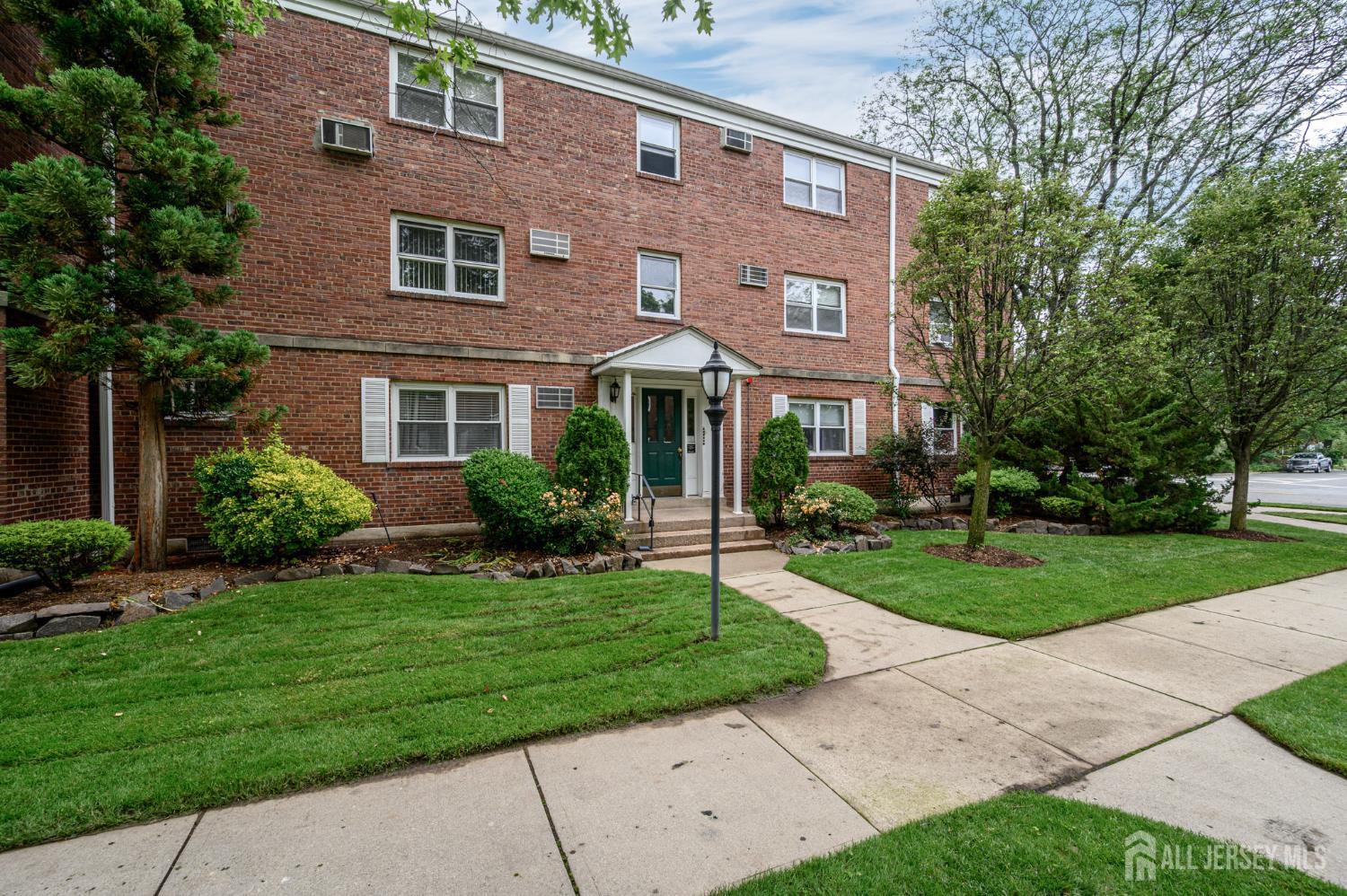 243 Johnson Avenue, Unit L5 Hackensack, NJ 07601 - Photo 19 of 24 a front view of a house with a yard