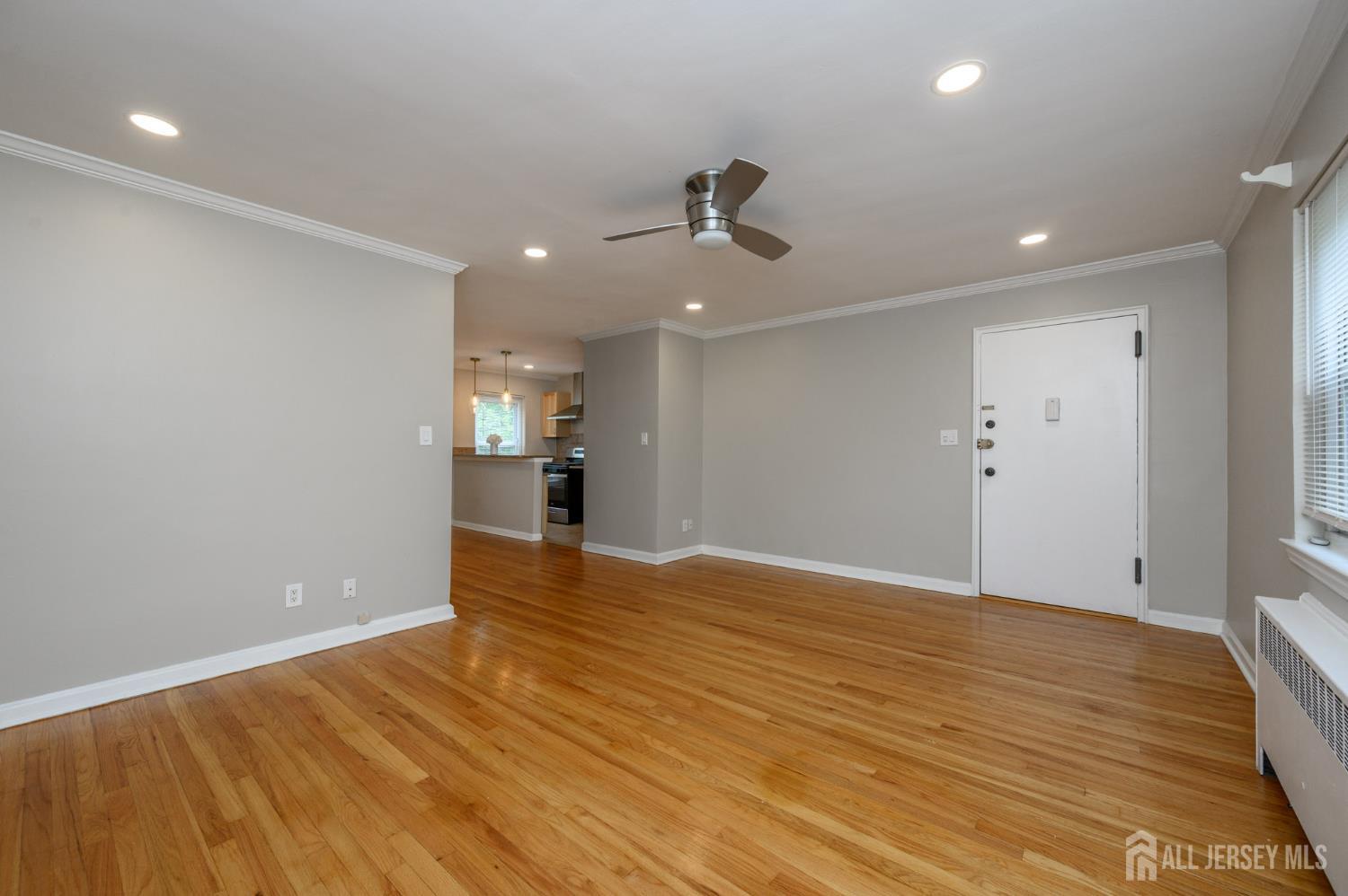243 Johnson Avenue, Unit L5 Hackensack, NJ 07601 - Photo 6 of 24 a view of empty room with wooden floor