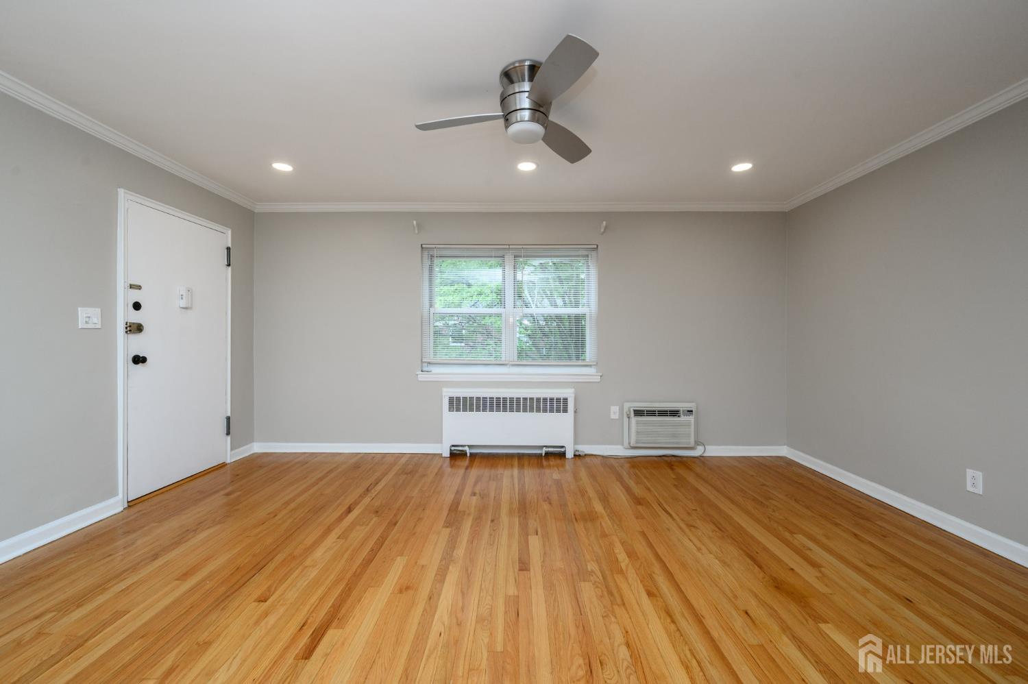 243 Johnson Avenue, Unit L5 Hackensack, NJ 07601 - Photo 7 of 24 a view of empty room with wooden floor and fan