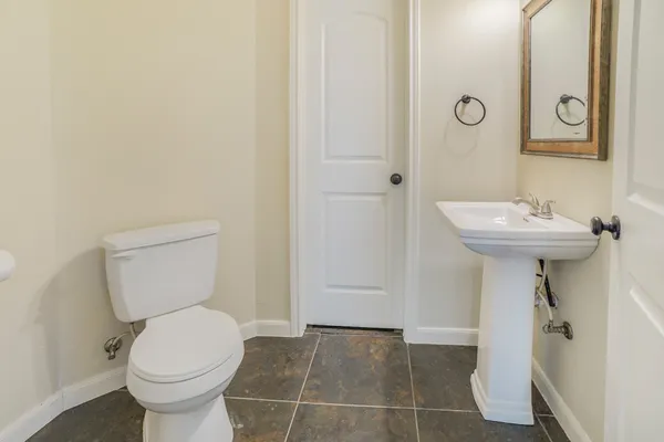 a bathroom with a sink toilet and a mirror