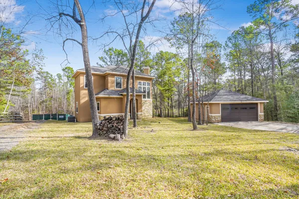 a yellow house with swimming pool in front of it