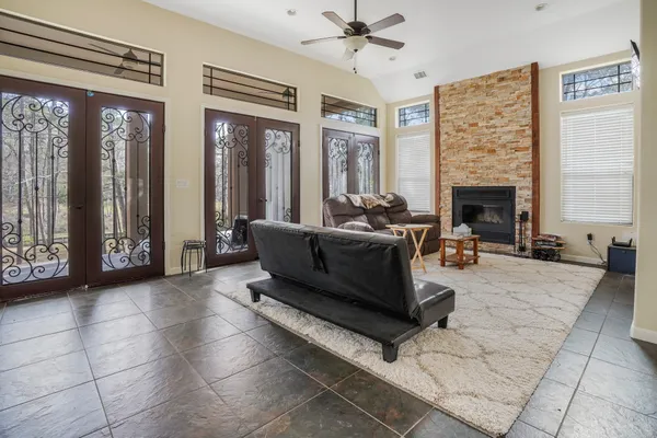 a living room with furniture a fireplace and a chandelier