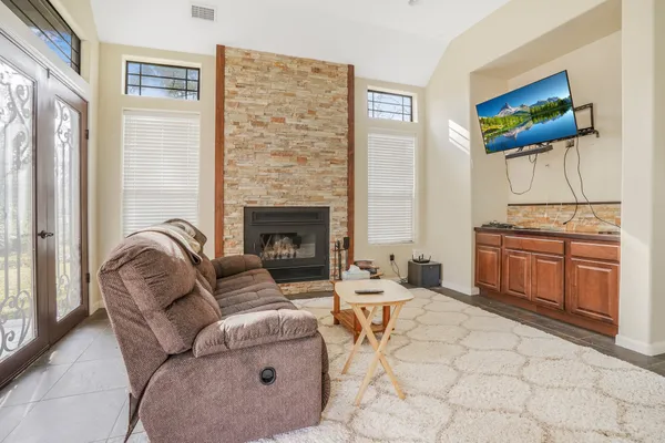 a living room with furniture a flat screen tv and a fireplace