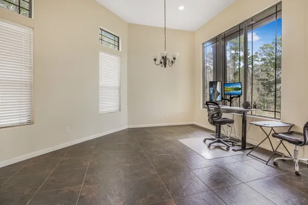 a view of a workspace with furniture and a window