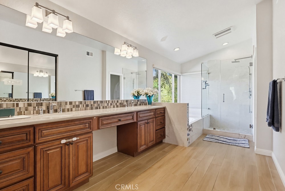 24303 East Rimford Place Diamond Bar, CA 91765 - Photo 17 of 39 a large bathroom with a large mirror vanity and a shower