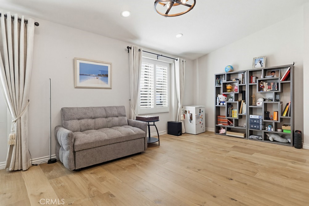 24303 East Rimford Place Diamond Bar, CA 91765 - Photo 23 of 39 a living room with furniture a window and gym equipment