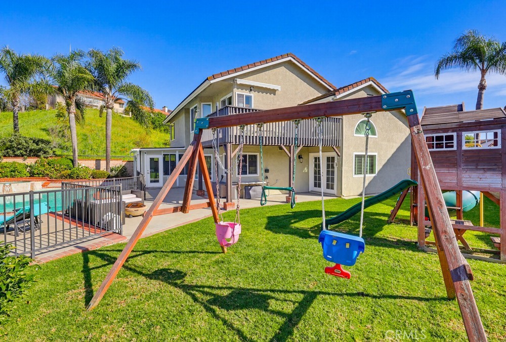 24303 East Rimford Place Diamond Bar, CA 91765 - Photo 34 of 39 a view of a house with a yard and potted plants