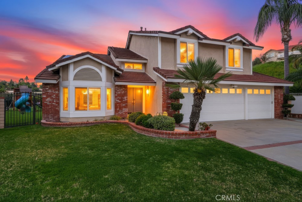 24303 East Rimford Place Diamond Bar, CA 91765 - Photo 35 of 39 a front view of a house with a yard