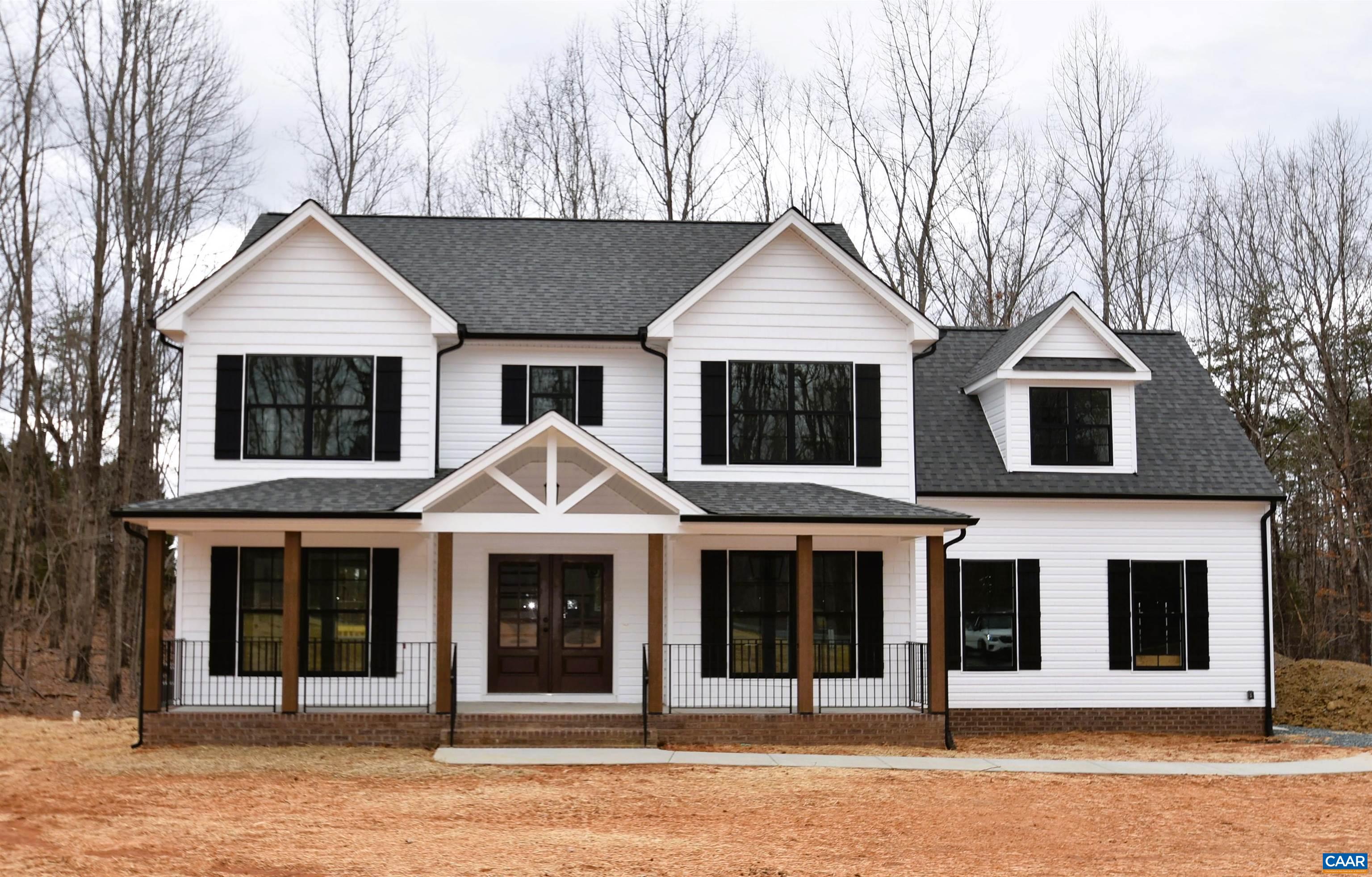 a view of a white house with large windows