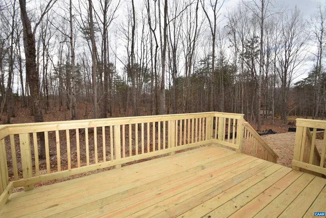 a view of wooden deck and trees