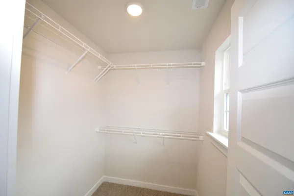 a view of a hallway with wooden shelves