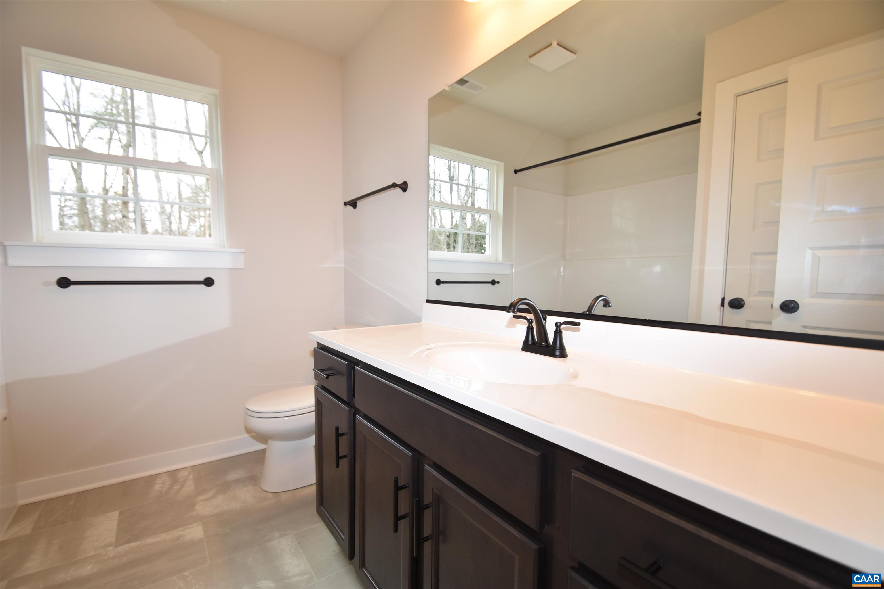 3 Chopt Road, Unit TC15B Kents Store, VA 23084 - Photo 23 of 33 a bathroom with a sink a toilet and a window