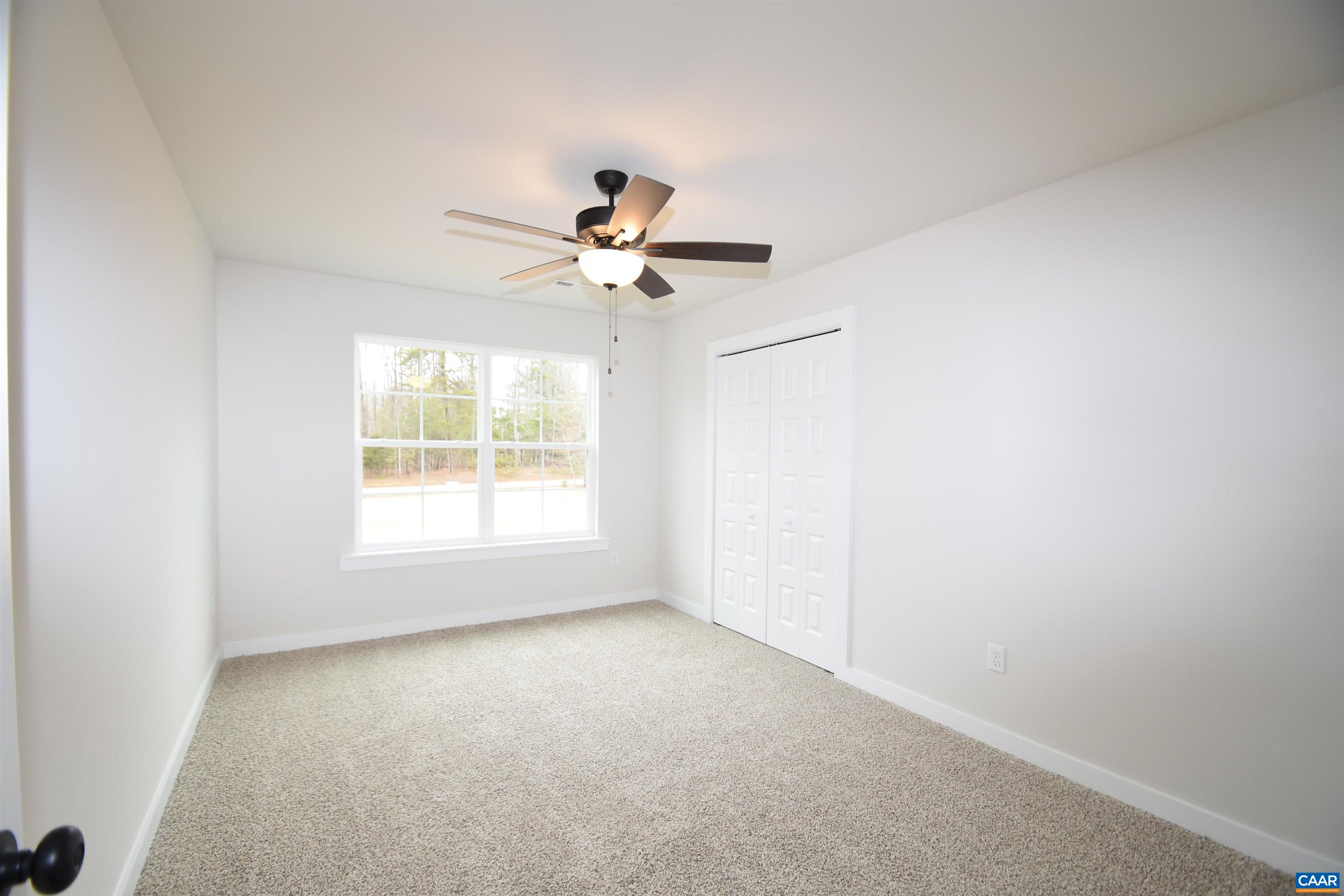 3 Chopt Road, Unit TC15B Kents Store, VA 23084 - Photo 27 of 33 an empty room with a window and a fan