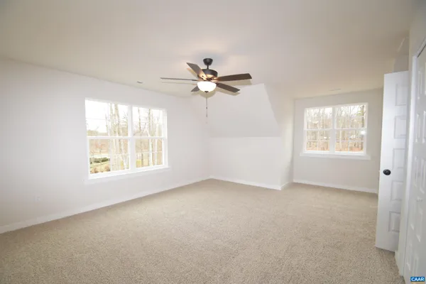 a view of a livingroom with a ceiling fan and window
