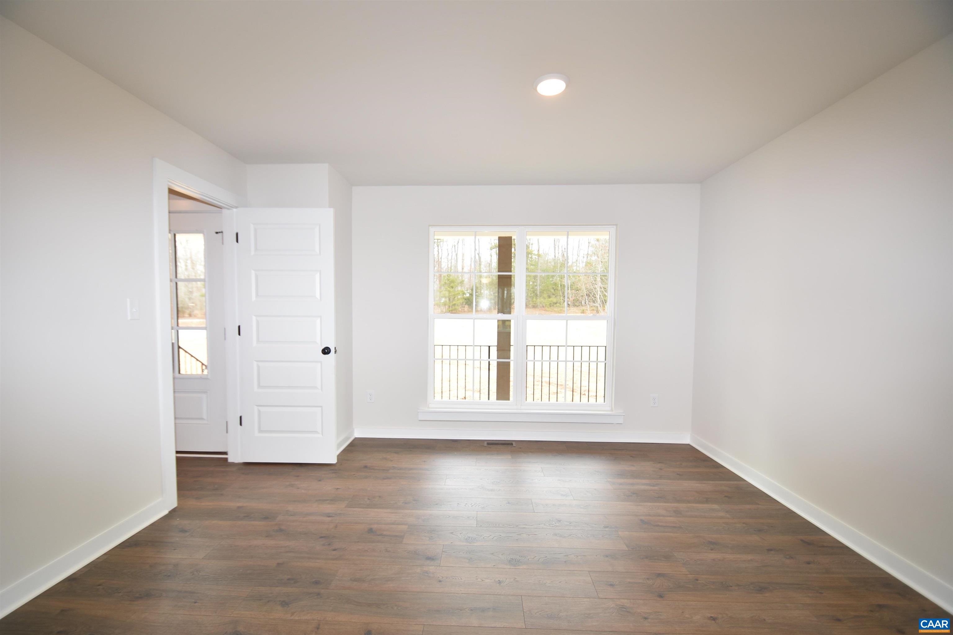 3 Chopt Road, Unit TC15B Kents Store, VA 23084 - Photo 6 of 33 an empty room with wooden floor and windows