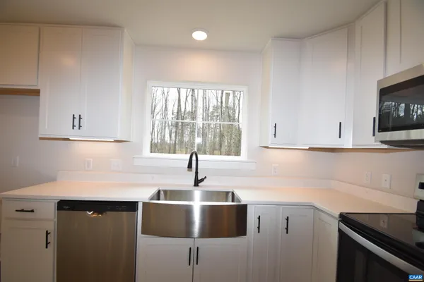 a kitchen with a sink cabinets and window