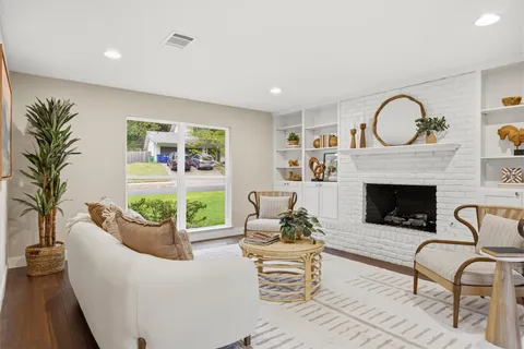 a kitchen with stainless steel appliances a dining table chairs refrigerator and sink