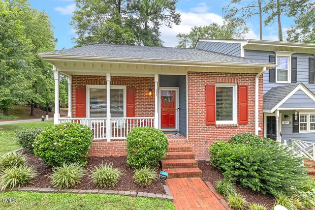 front view of a brick house with a yard