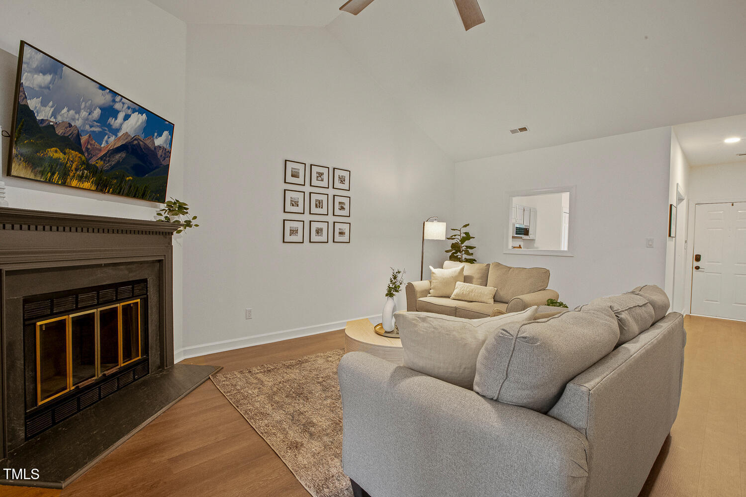 217 Danforth Drive Cary, NC 27511 - Photo 18 of 40 a living room with furniture a flat screen tv and a fireplace