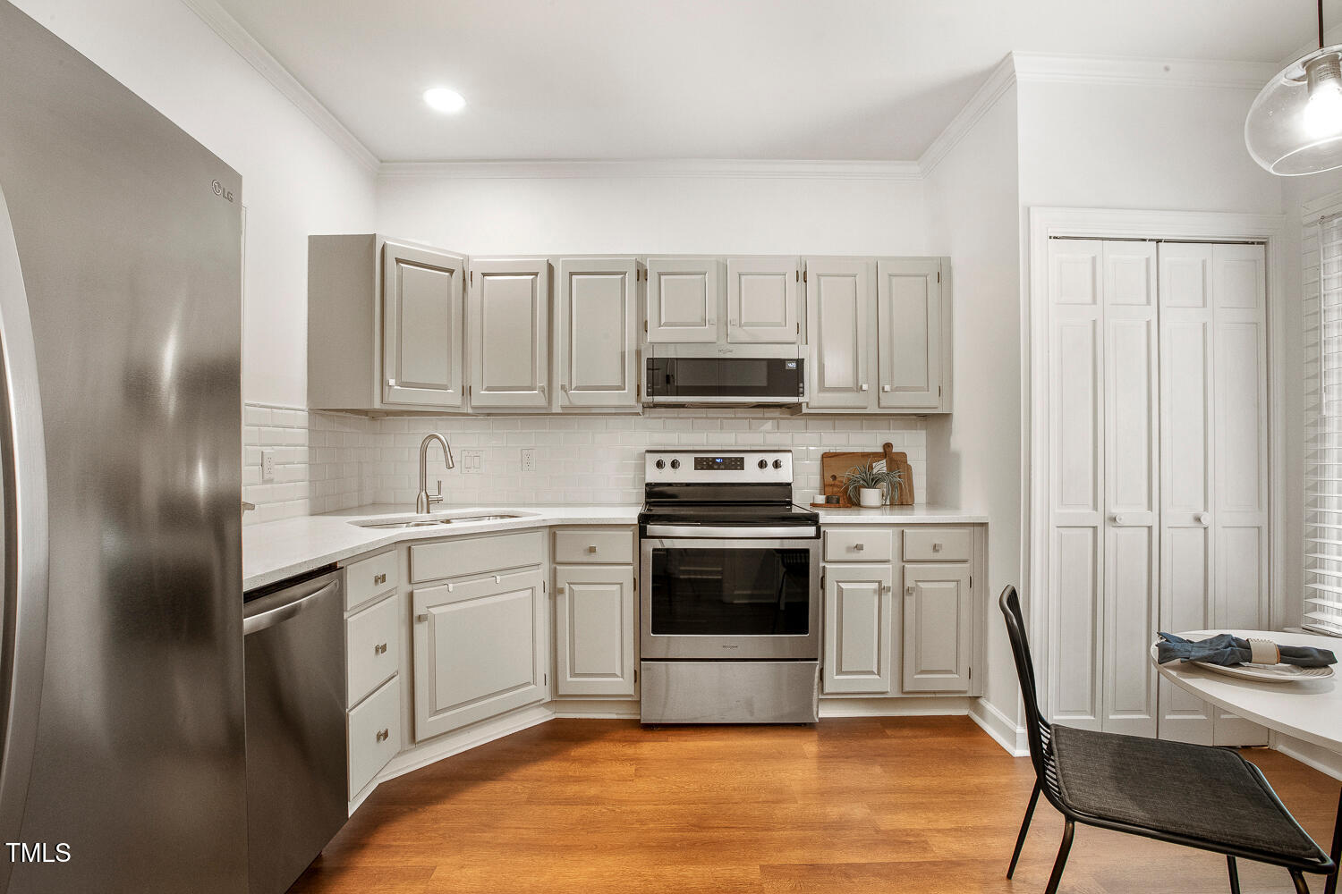 217 Danforth Drive Cary, NC 27511 - Photo 7 of 40 a kitchen with stainless steel appliances a stove a sink and a refrigerator