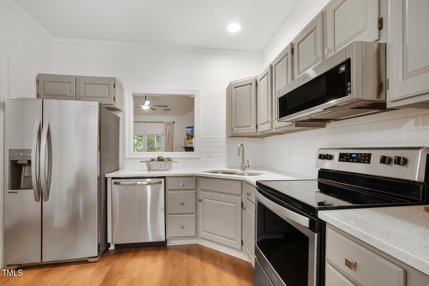 217 Danforth Drive Cary, NC 27511 - Photo 8 of 40 a kitchen with stainless steel appliances a sink a stove a microwave a refrigerator a sink and cabinets