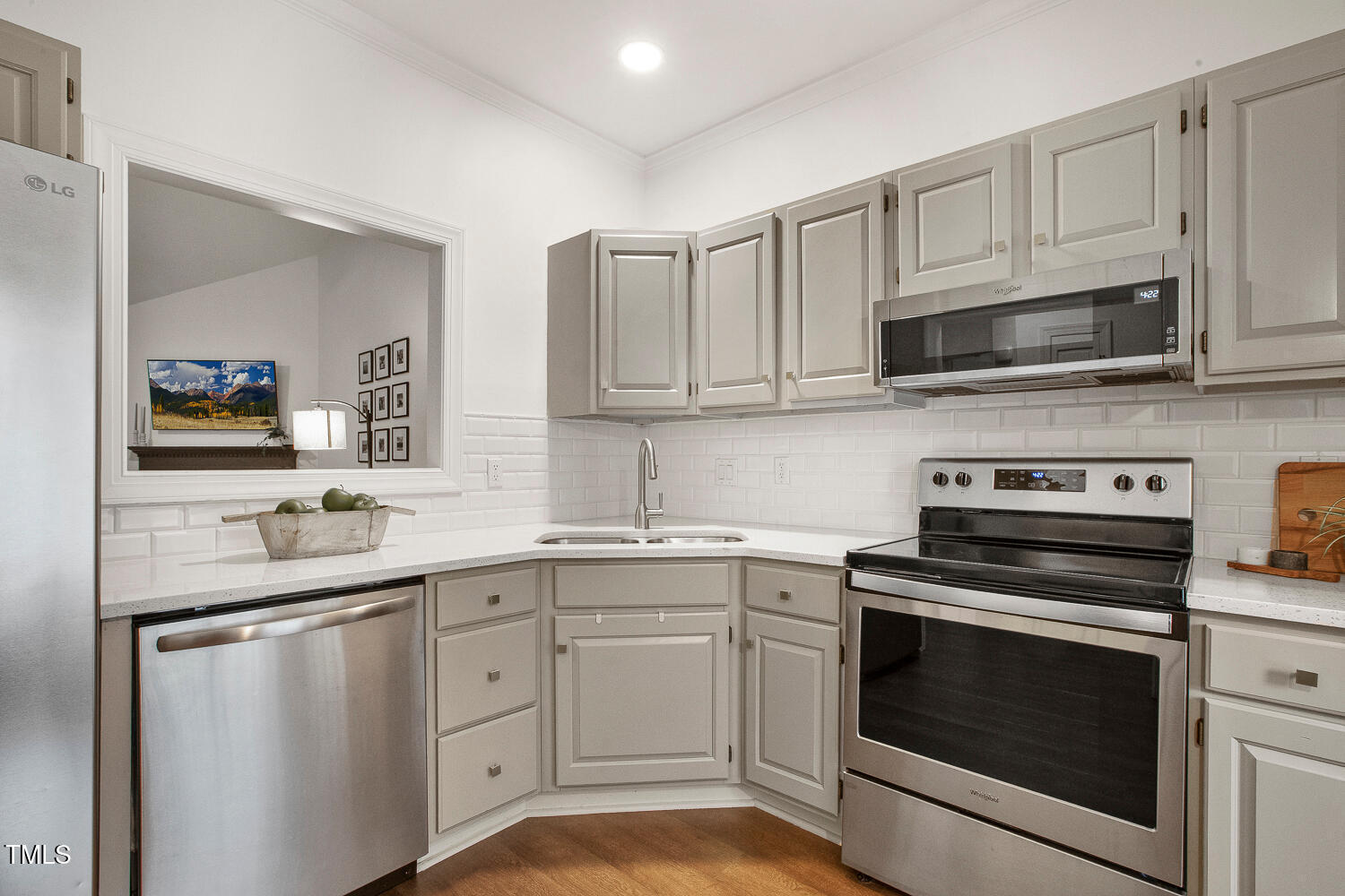 217 Danforth Drive Cary, NC 27511 - Photo 9 of 40 a kitchen with white cabinets and stainless steel appliances