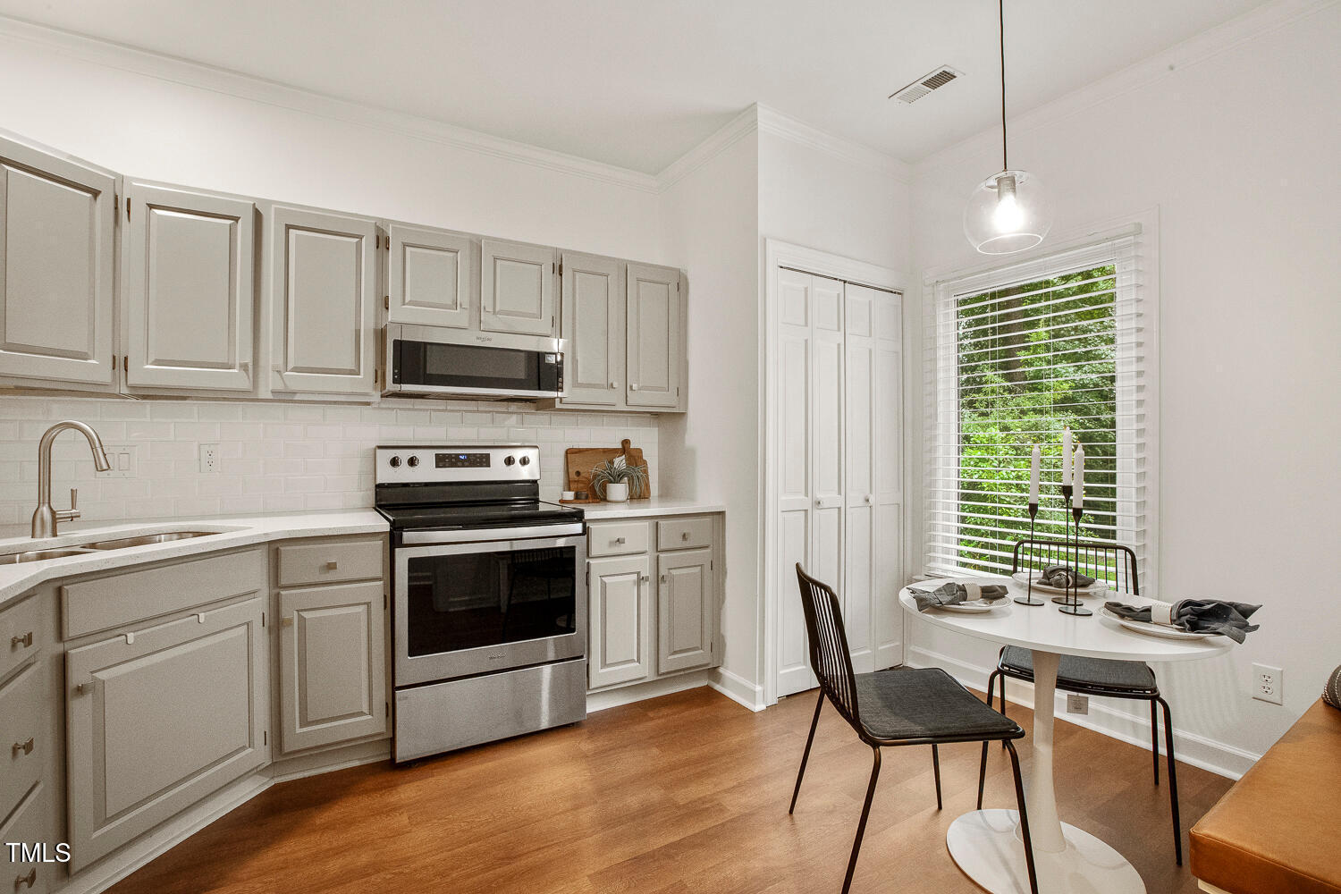 217 Danforth Drive Cary, NC 27511 - Photo 10 of 40 a kitchen with a stove a sink and a microwave