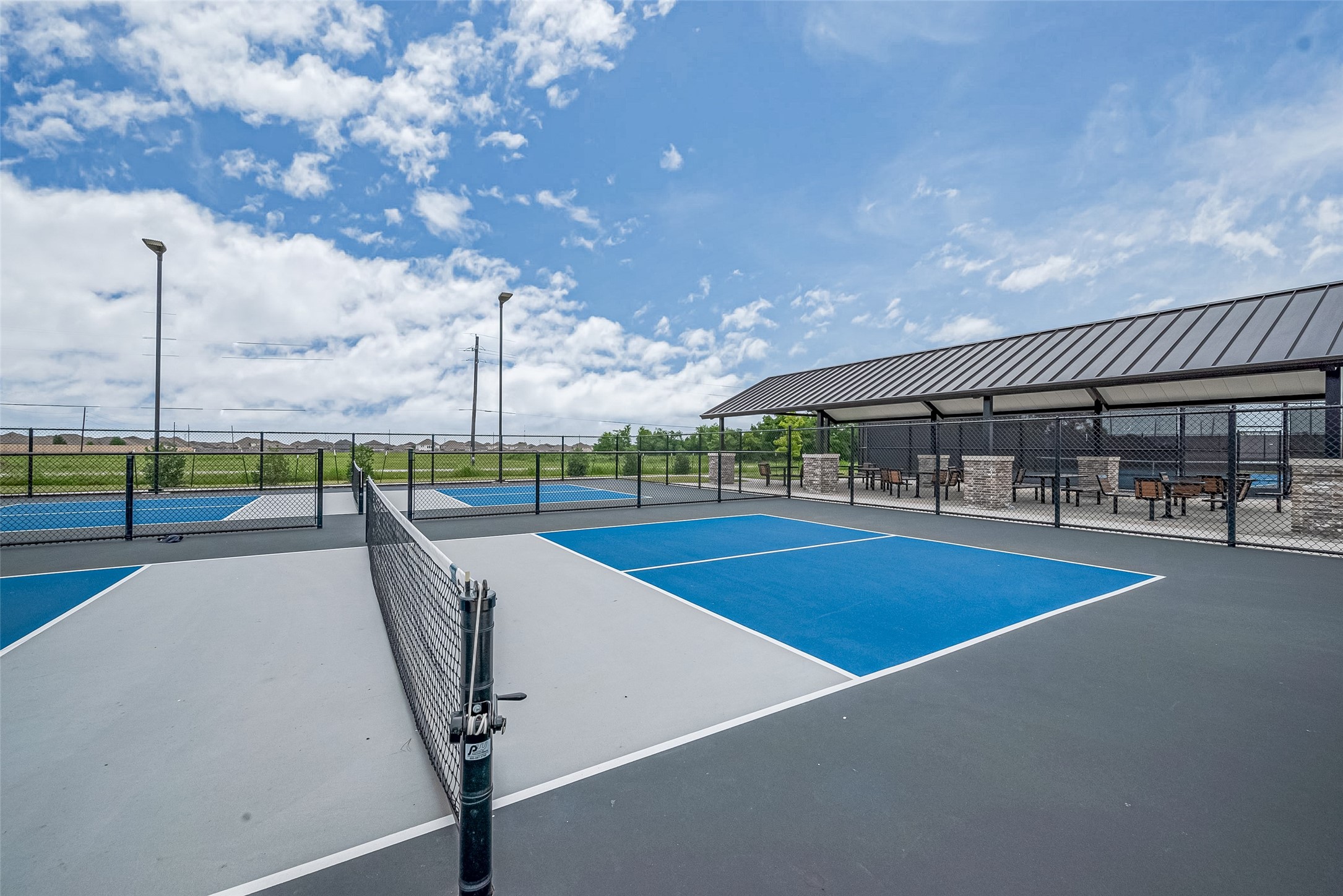 1214 Red Hills Drive Rosharon, TX 77583 - Photo 43 of 46 a view of a swimming pool with lawn chairs and floor to ceiling window
