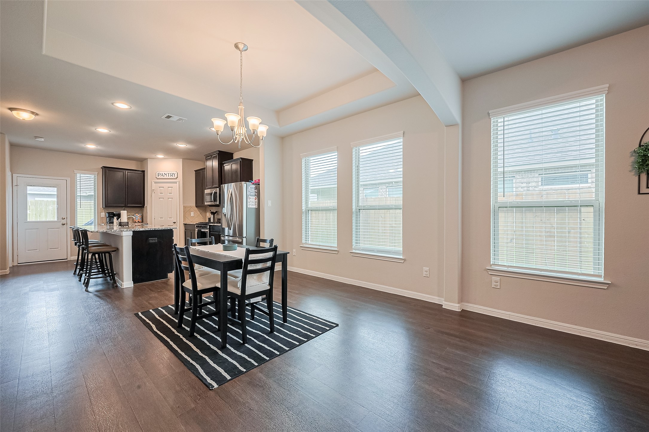 1214 Red Hills Drive Rosharon, TX 77583 - Photo 9 of 46 an open kitchen with dining table and chairs