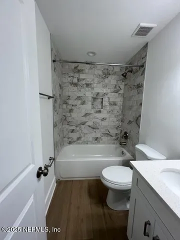 a bathroom with a sink a toilet and a bathtub