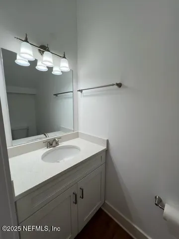 a bathroom with a sink vanity and a mirror