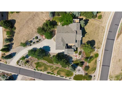 a view of a house with backyard and sitting area