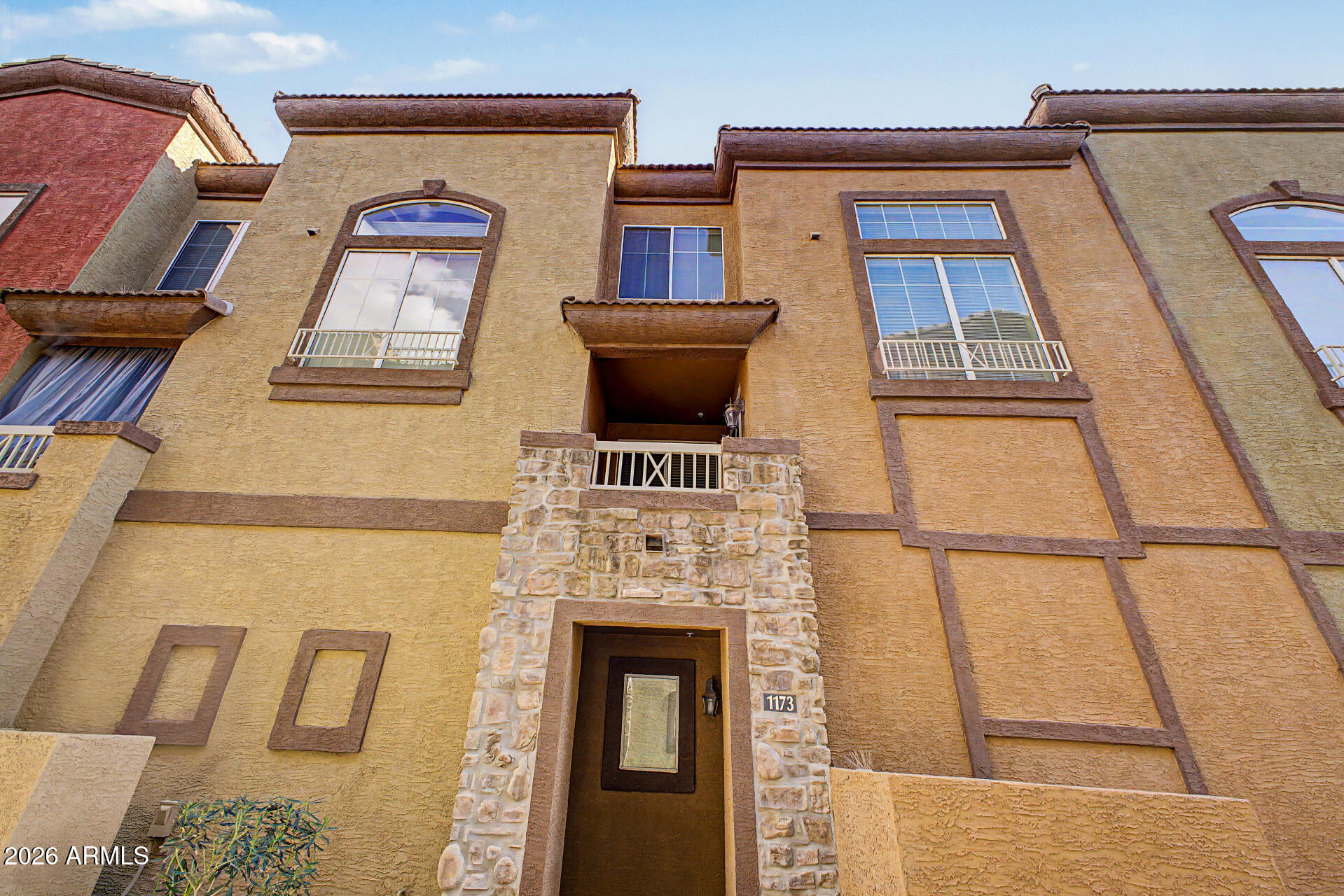 a front view of a house with large windows