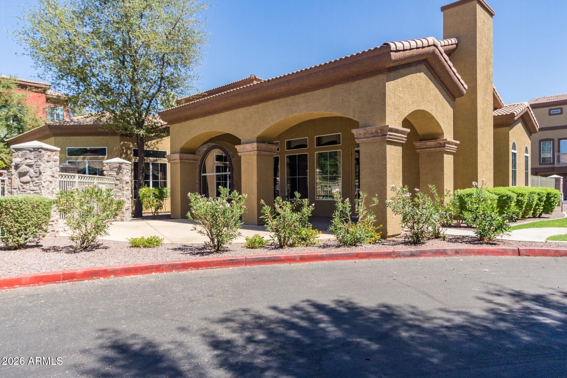 1920 East Bell Road, Unit 1173 Phoenix, AZ 85022 - Photo 26 of 33 a front view of a house with a yard