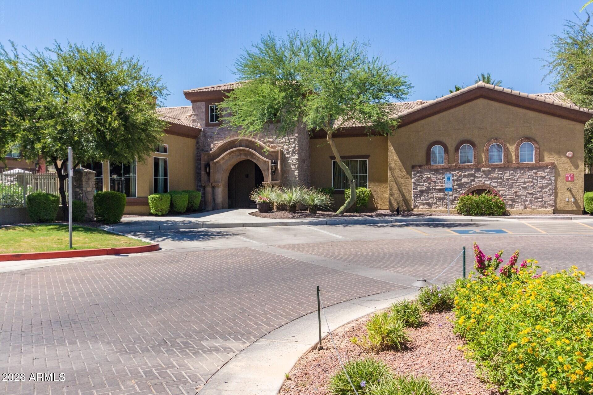 1920 East Bell Road, Unit 1173 Phoenix, AZ 85022 - Photo 27 of 33 a front view of a house with a yard and a garage