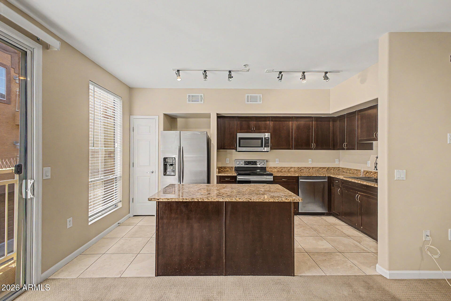 1920 East Bell Road, Unit 1173 Phoenix, AZ 85022 - Photo 7 of 33 a kitchen with granite countertop a sink a counter top space and stainless steel appliances