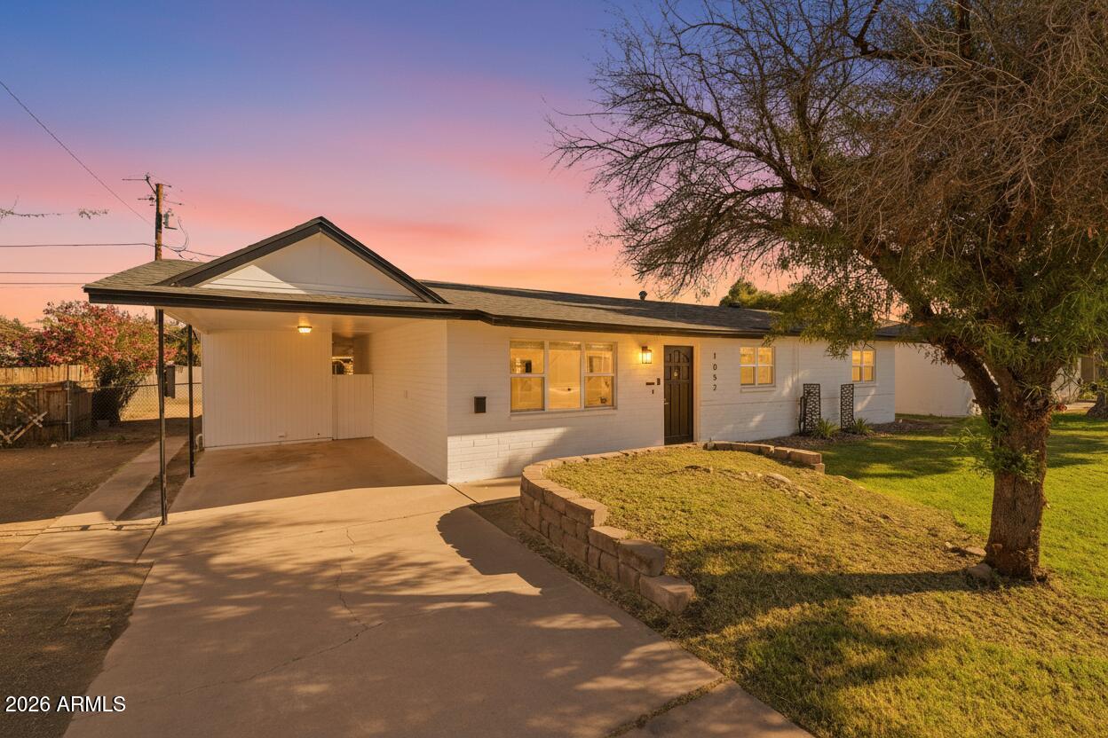 1052 West Elna Rae Street Tempe, AZ 85281 - Photo 1 of 16 a front view of a house with a yard